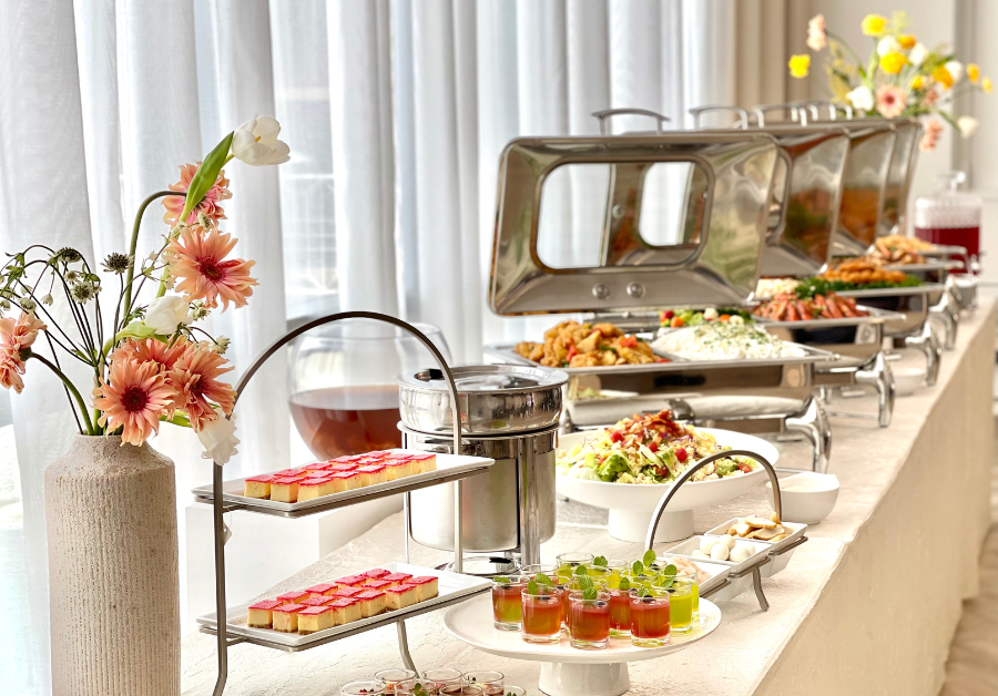 Buffet setup, dishes in buffet warmers, dessert station with sweets on pastry tray, dessert on shooters