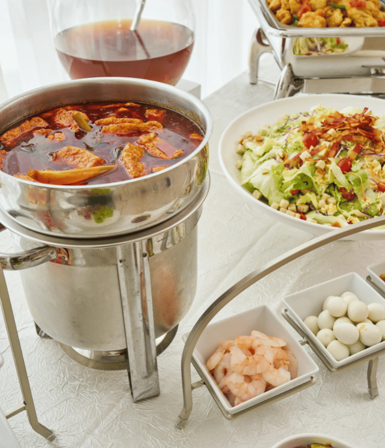 Large pot with soup and garnishing ingredients on square bowls